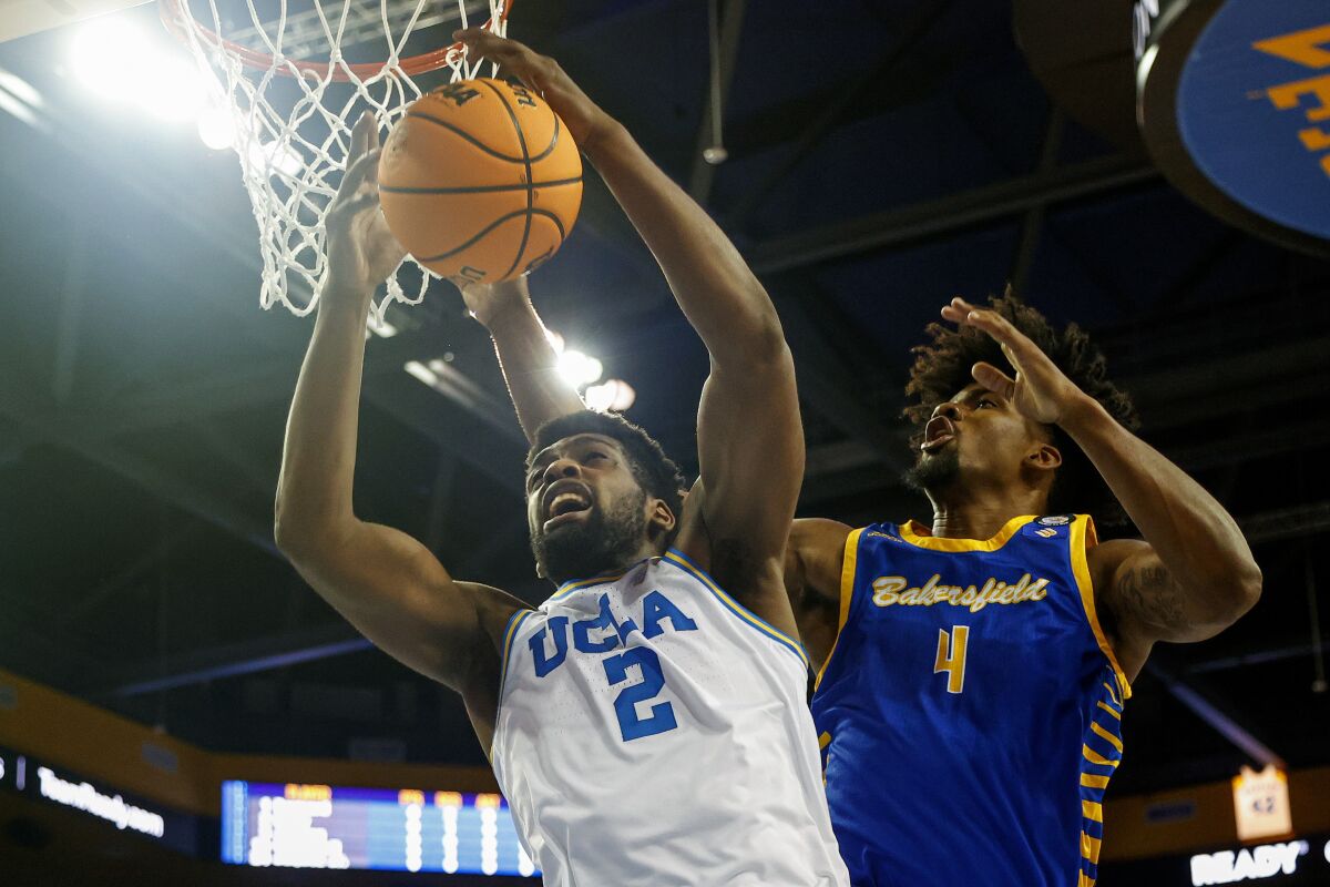 UCLA forward Cody Riley (2) grabs a rebound next to Cal State Bakersfield guard Antavion Collum (4) during the first half of an NCAA college basketball game Tuesday, Nov. 9, 2021, in Los Angeles. (AP Photo/Ringo H.W. Chiu)