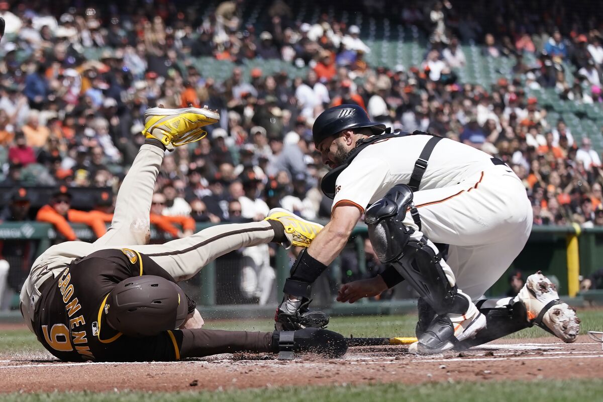 Giants catcher Curt Casali tags the Padres' Jake Cronenworth out at home 