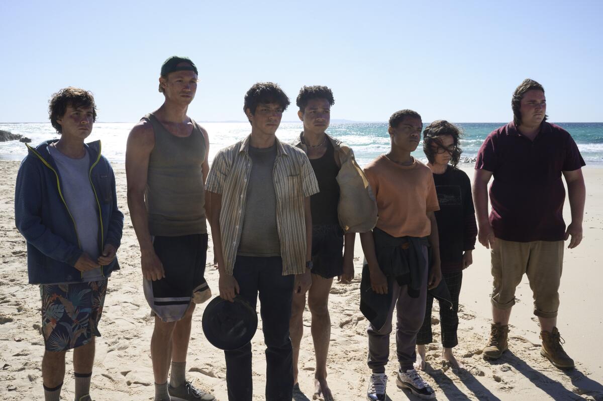 A bunch of teenage castaways on a beach.