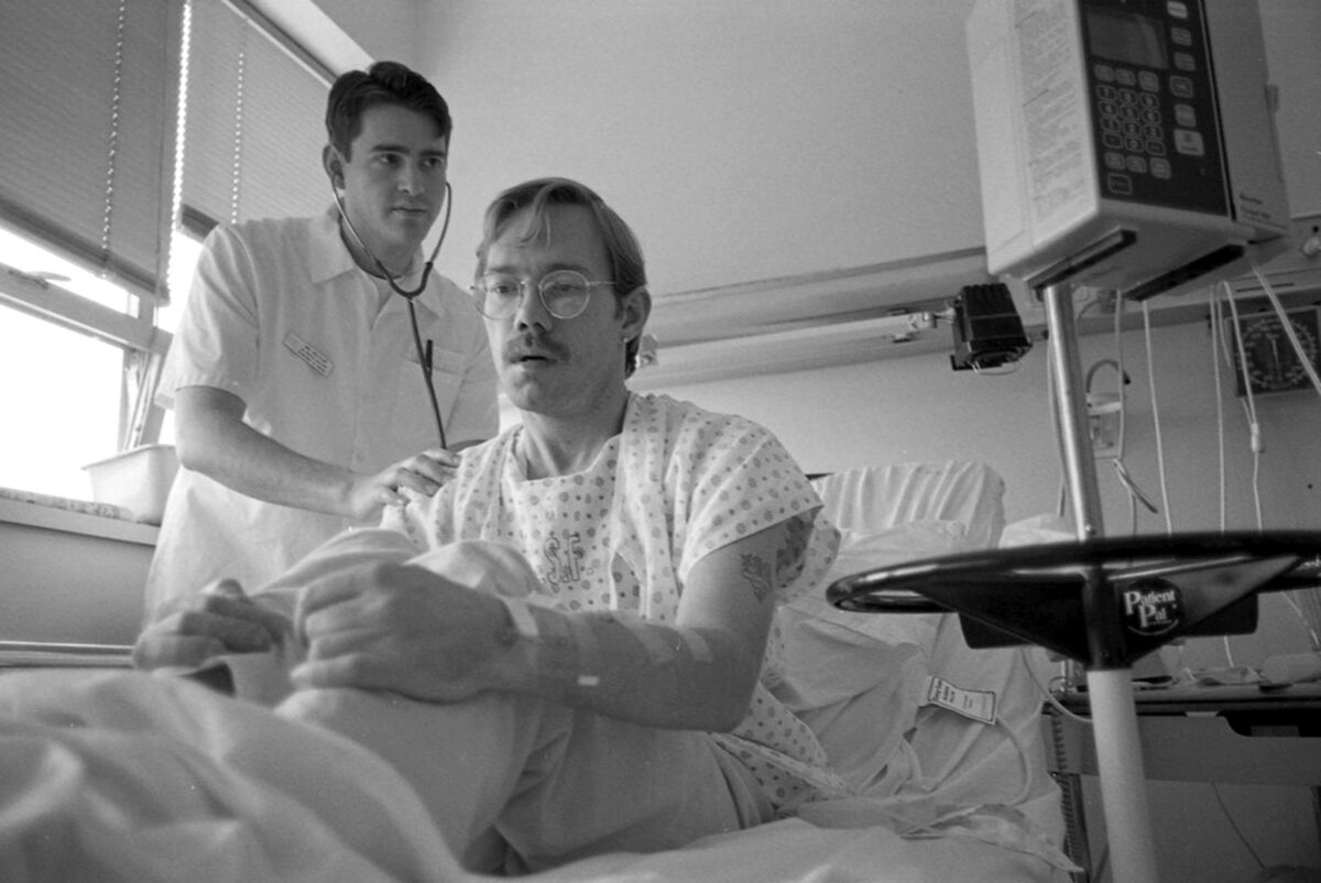 Mount Zion nursing assistant Michael Wollflair examines patient David Earl in 1994. (UC San Francisco)