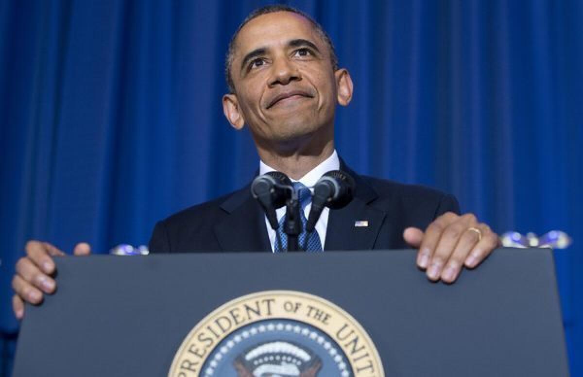 President Obama listens as a protester shouts during a speech about his administration's drone and counterterrorism policies, as well as the military prison at Guantanamo Bay, at the National Defense University in Washington, DC.