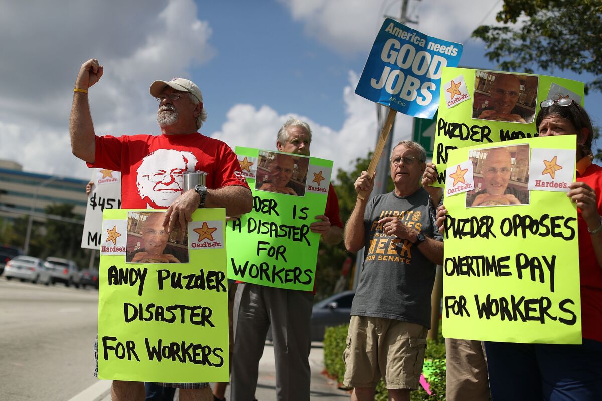 Don Abicht, left, joins with other South Florida union members and activists on Thursday as they protest in front of the district office of Sen. Marco Rubio (R-Fla.), asking him to vote against Labor secretary nominee Andy Puzder.