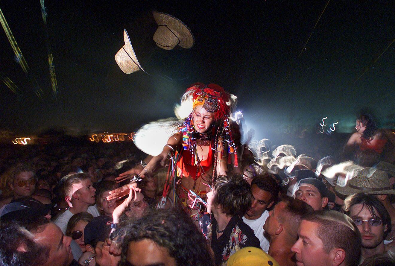 People on stilts make their way to the front of the main stage, April 28, 2001.