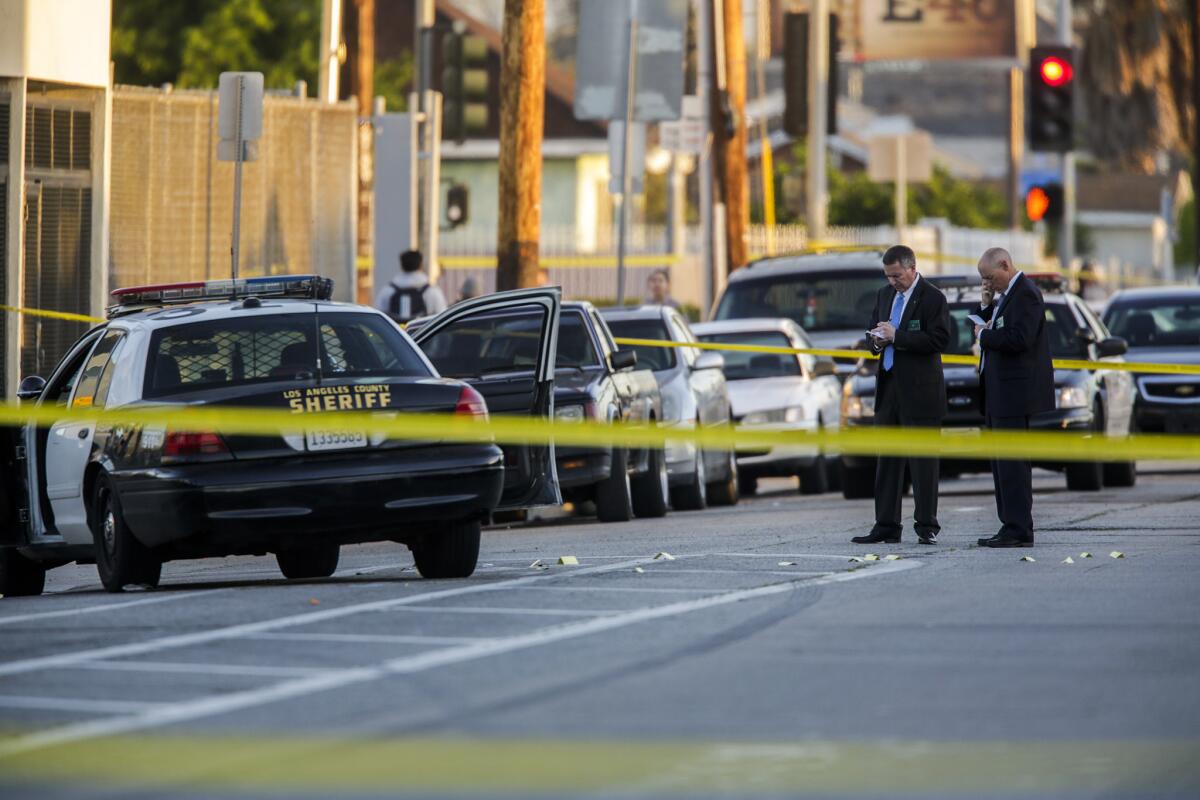 Detectives investigate the fatal shooting of a man by Los Angeles County sheriff's deputies at Holmes Avenue and 64th Street in the Florence-Firestore area.