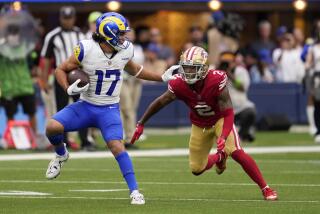 Los Angeles Rams wide receiver Puka Nacua, left, tries to fend off San Francisco 49ers cornerback Deommodore Lenoir during the second half of an NFL football game Sunday, Sept. 17, 2023, in Inglewood, Calif. (AP Photo/Ashley Landis)