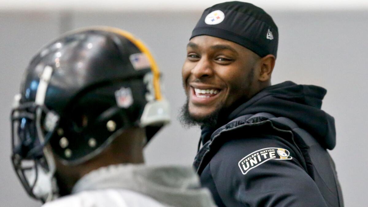 Pittsburgh Steelers running back Le'Veon Bell smiles while talking to teammate Fitzgerald Toussaint during practice on Thursday.