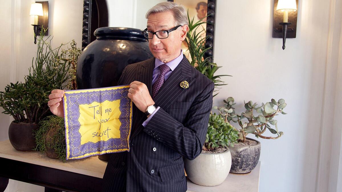 Director Paul Feig holds a purple and yellow pocket square from his upcoming collaboration with Anderson & Sheppard. It bears the words "Tell me your secret," a reference to Feig's film "A Simple Favor," which hits theaters Sept. 14.