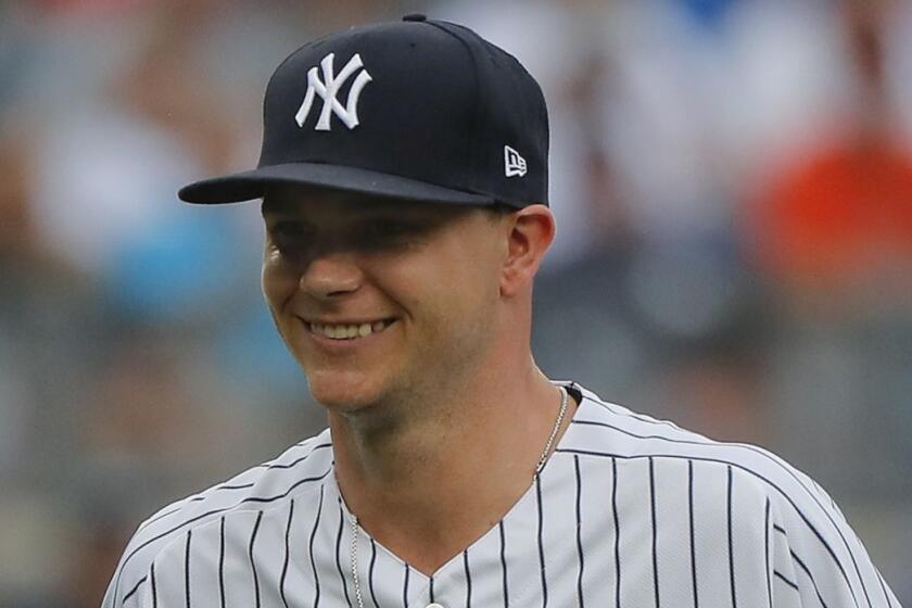 New York Yankees starting pitcher Sonny Gray, left, reacts as he leaves the game during the third inning of a baseball game against the Baltimore Orioles, Wednesday, Aug. 1, 2018, in New York. The Orioles won 7-5. (AP Photo/Julie Jacobson)