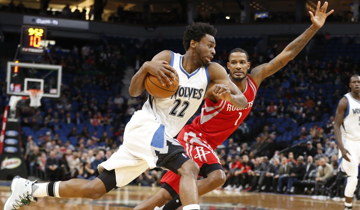 Minnesota Timberwolves' Andrew Wiggins, left, races by as Houston Rockets' Trevor Ariza pursues during the first quarter on Wednesday.