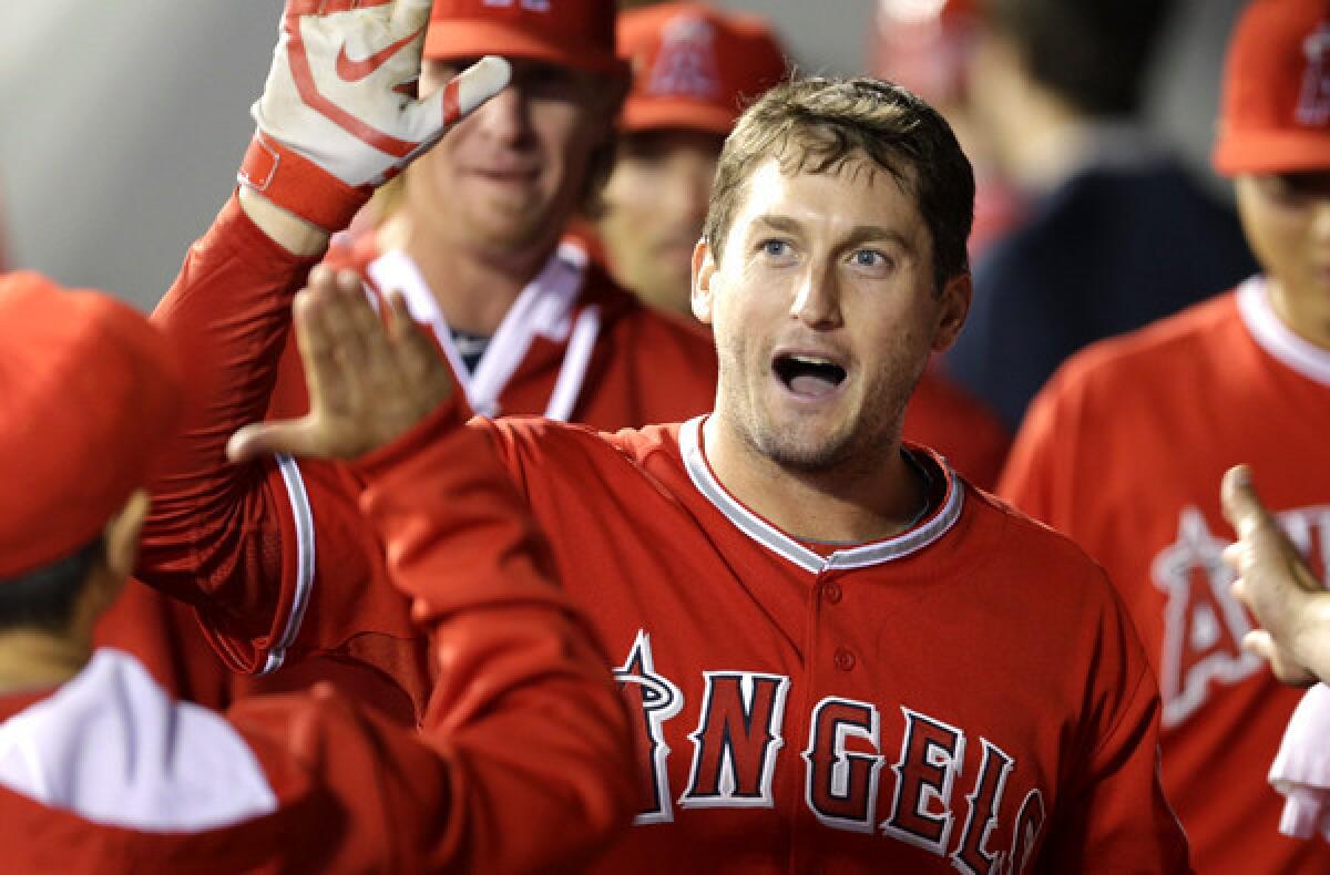 Angels third baseman David Freese is congratulated in the dugout after he hit a solo home run against the Seattle Mariners on Tuesday.