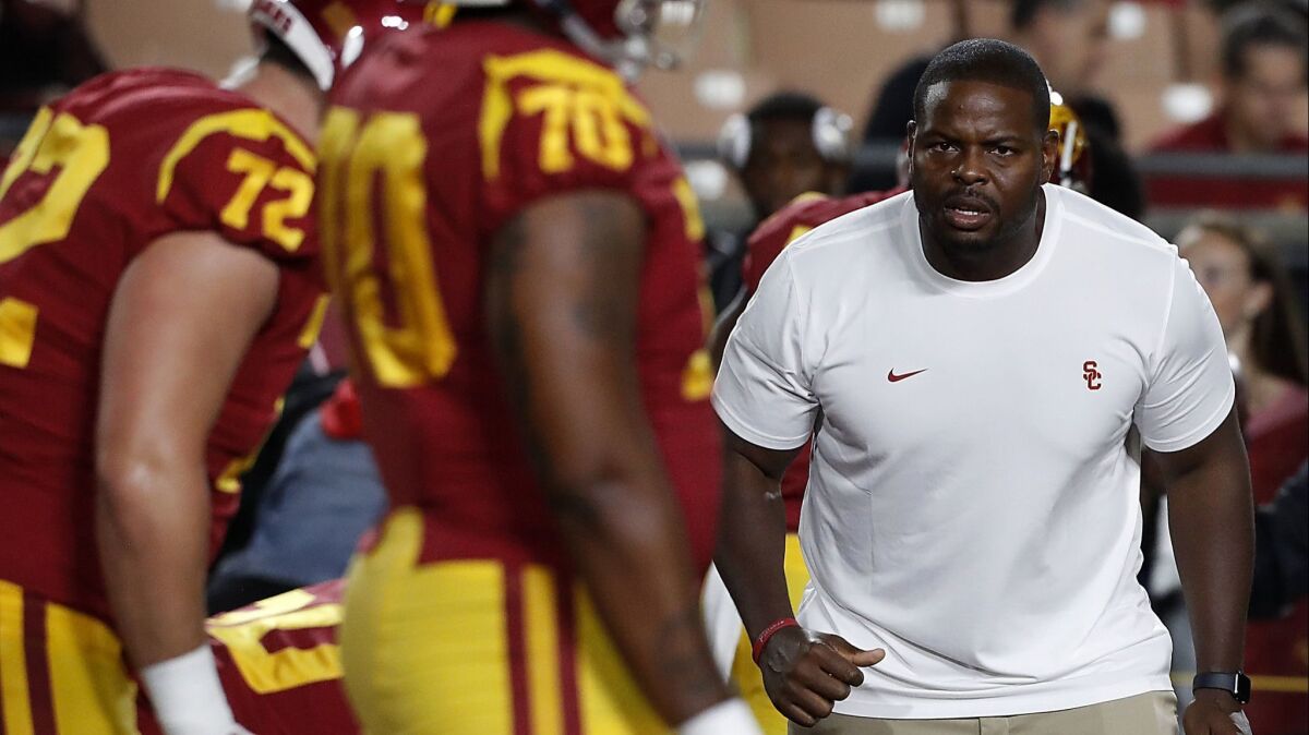 Kenechi Udeze coaches the USC defensive line during a game against Colorado on Oct. 13.