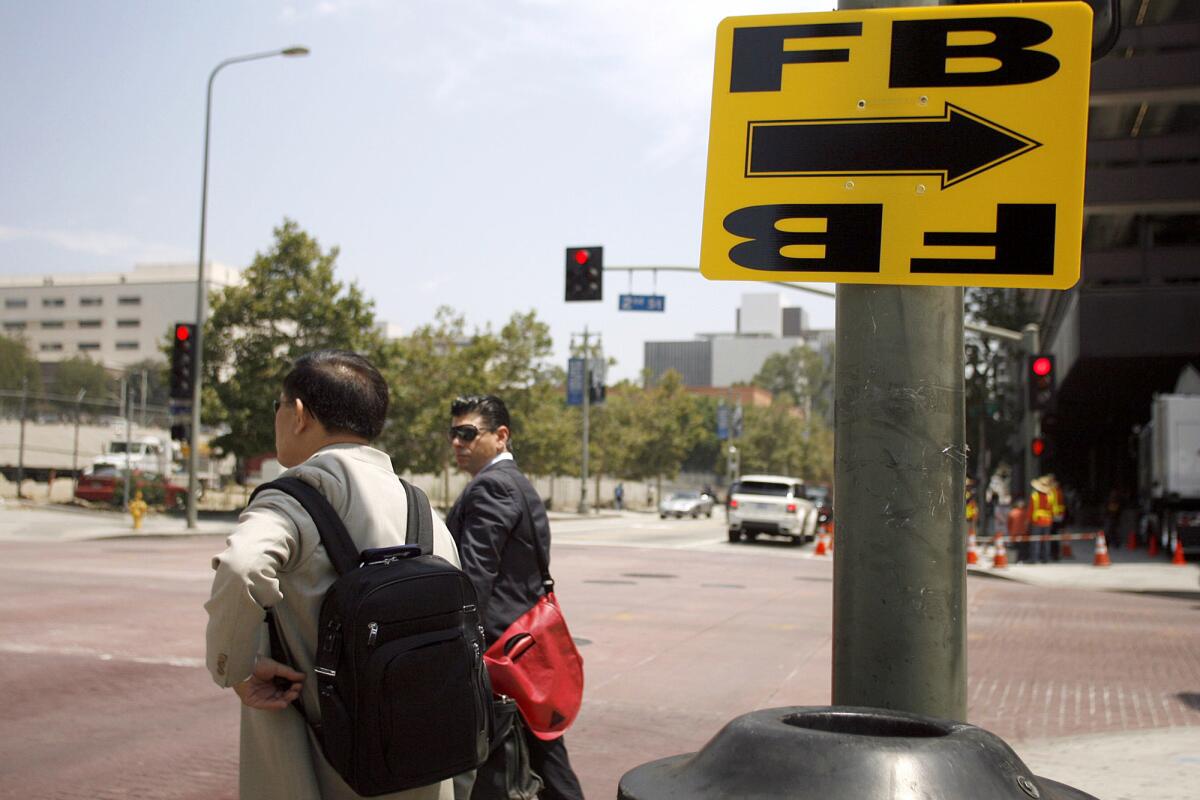 A yellow sign posted during a film production on 2nd St. near Broadway in Los Angeles in 2013. A recent USC study about the effectiveness of film tax credits has come under fire by the MPAA.
