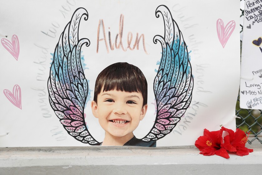 A photo of Aiden Leos at a memorial shrine on a viaduct over Highway 55 in Orange in June.
