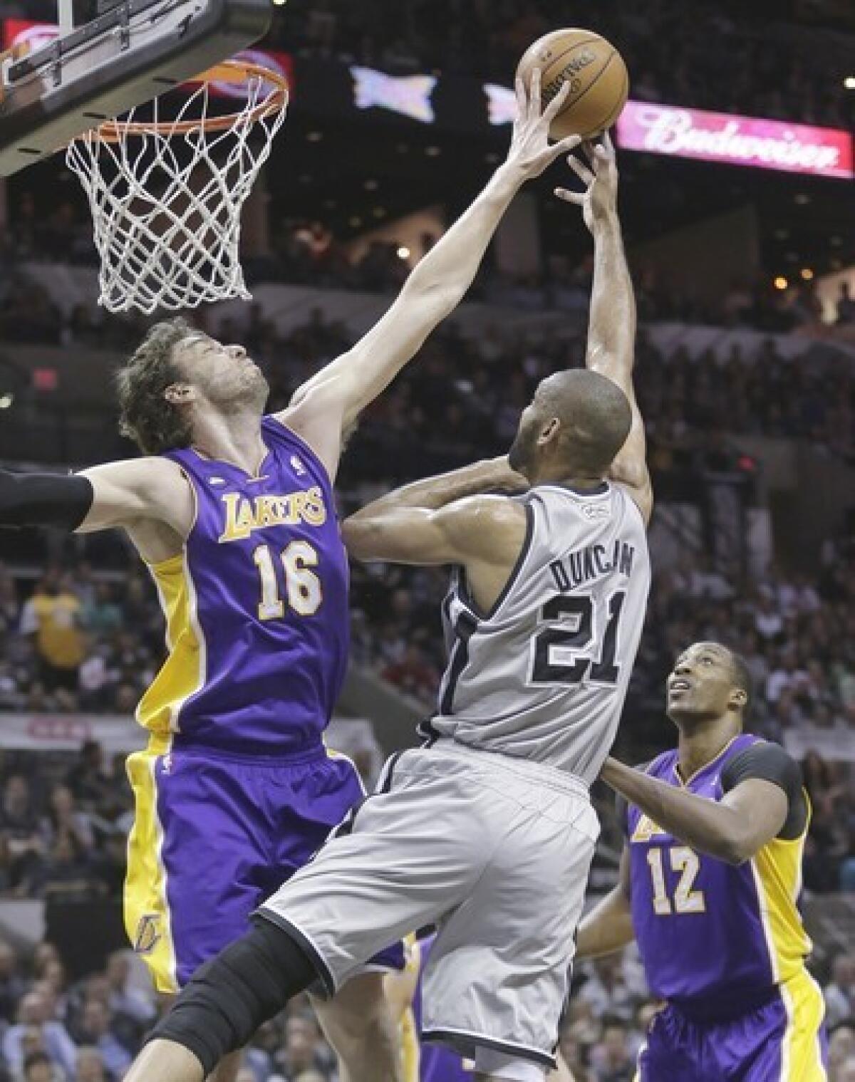 Lakers power forward Pau Gasol blocks a shot by Spurs power forward Tim Duncan.