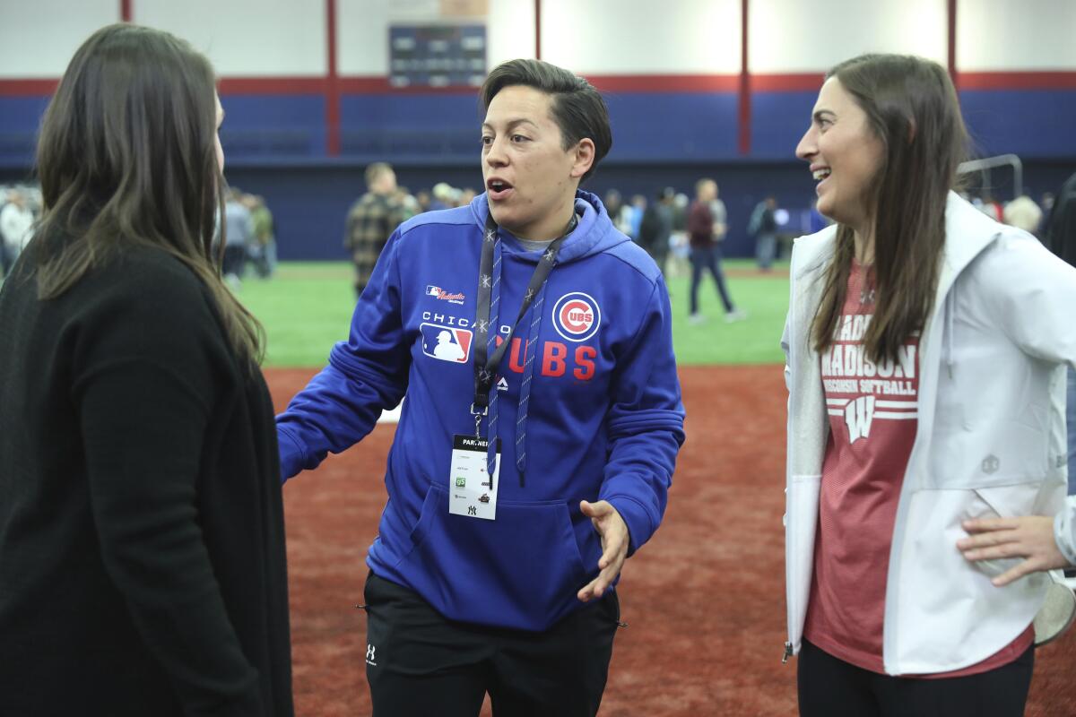 Chicago Cubs minor league hitting coach Rachel Folden, center, talks with colleagues during a hitting clinic at the University of Illinois at Chicago, Saturday, Nov. 23, 2019. None of the players care all that much that one of their coaches is a woman. The girls she encounters, they care very much that one of the coaches is a woman. (John J. Kim/Chicago Tribune via AP)