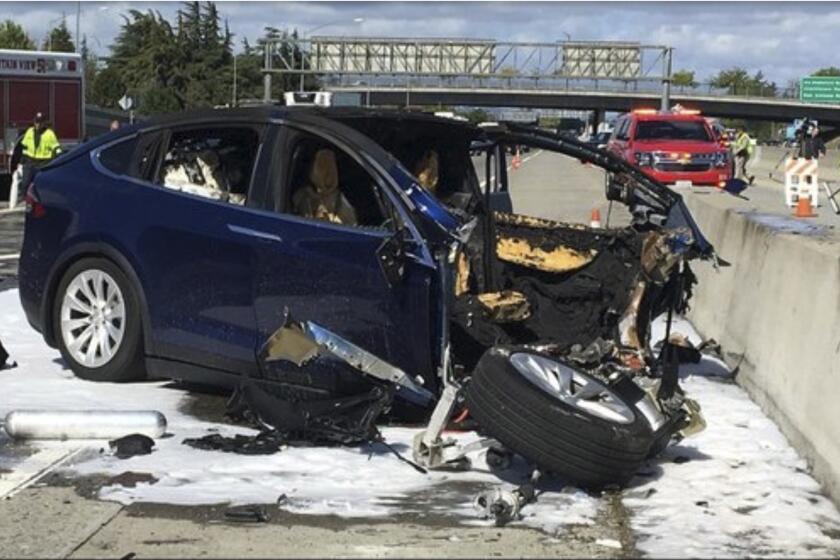 March 23, 2018 photo provided by KTVU, emergency personnel work a the scene where a Tesla electric SUV crashed into a barrier on U.S. Highway 101 in Mountain View, Calif. The NTSB probe into this Tesla crashe involving the Autopilot system is still pending.