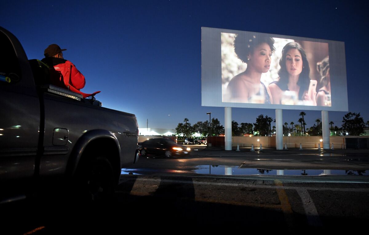 Sal Barbosa relaxes in the back of his pickup truck before a movie at Paramount Drive-In on Tuesday.