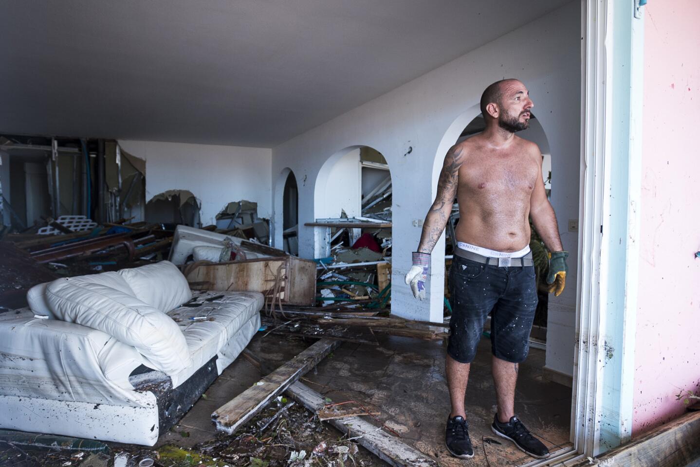 A man reacts as he stands in his destroyed home on September 7, 2017 in Orient Bay on the French Carribean island of Saint-Martin, after the passage of Hurricane Irma. France, the Netherlands and Britain on September 7 rushed to provide water, emergency rations and rescue teams to territories in the Caribbean hit by Hurricane Irma, with aid efforts complicated by damage to local airports and harbours. The worst-affected island so far is Saint Martin, which is divided between the Netherlands and France, where French Prime Minister Edouard Philippe confirmed four people were killed and 50 more injured.