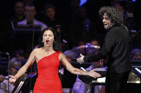 Gustavo Dudamel's series of firsts at the Hollywood Bowl continued Aug. 1 with the Los Angeles Philharmonic's young music director making his first U.S. appearance as an opera conductor. The material, "Carmen," was well-suited to his widely known and much loved expressiveness. Natascha Petrinsky sang the title role.