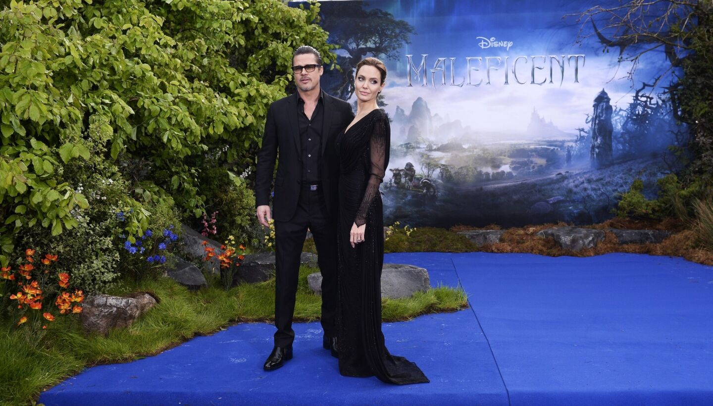 Brad Pitt and Angelina Jolie arrive for a special "Maleficent" costume display at Kensington Palace in London on May 8, 2014.