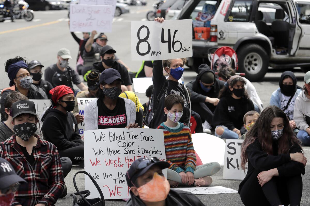 A protester holds a sign that reads "8:46" in Tacoma, Wash., during a protest after the death of George Floyd.