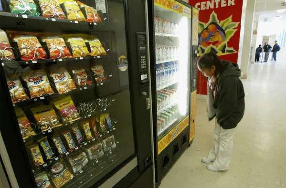 A student buys snacks from a vending machine at Mission High School in San Francisco.