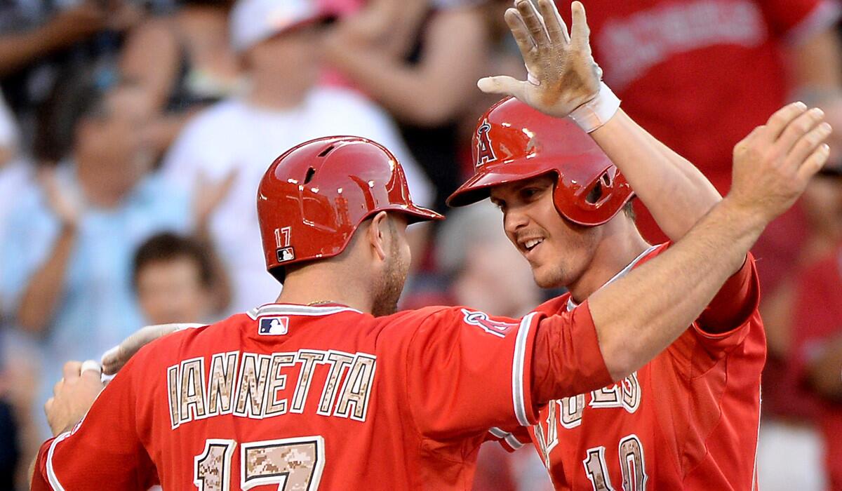 Grant Green (10) is congratulated by Angels catcher Chris Iannetta after hitting a two-run home run against the Rays earlier this season.