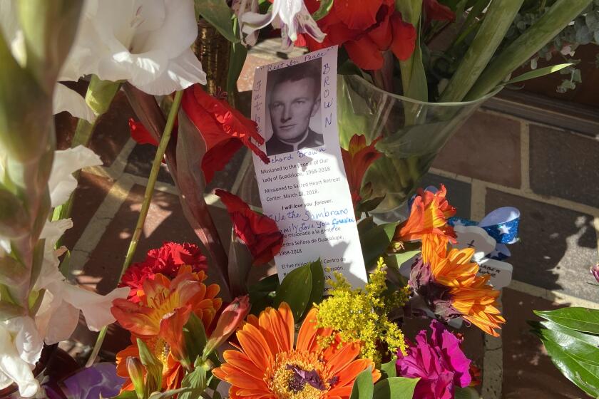 Adorners of Father Richard Brown left flowers and notes near Our Lady of Guadalupe church upon learning of his death.
