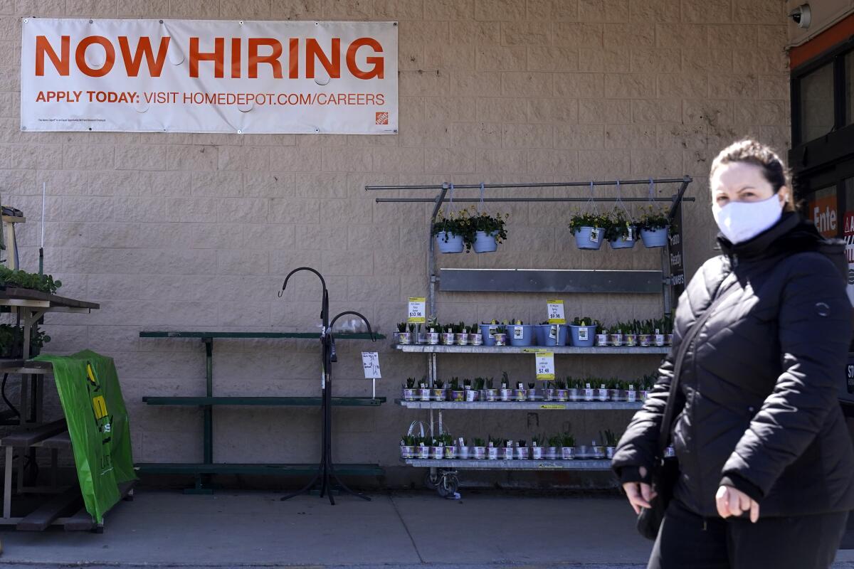 A hiring sign is seen outside home improvement store in Mount Prospect, Ill., Friday, April 2, 2021. America's employers unleashed a burst of hiring in March, adding 916,000 jobs in a sign that a sustained recovery from the pandemic recession is taking hold as vaccinations accelerate, stimulus checks flow through the economy and businesses increasingly reopen. (AP Photo/Nam Y. Huh)