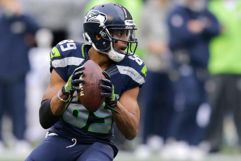 Seattle receiver Doug Baldwin gets set to pass to quarterback Russell Wilson against Philadelphia on Sunday.