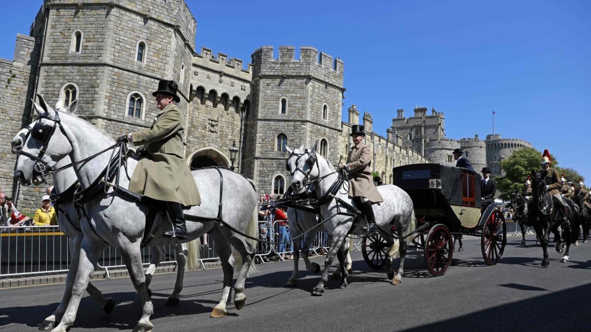 A royal carriage passes the Henry VIII gate of Windsor Castle on Thursday during rehearsal for Saturday's wedding procession.