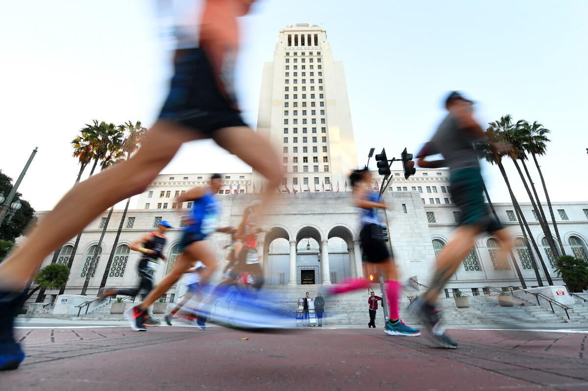 Competitors run past L.A. City Hall during the 2018 L.A. Marathon.