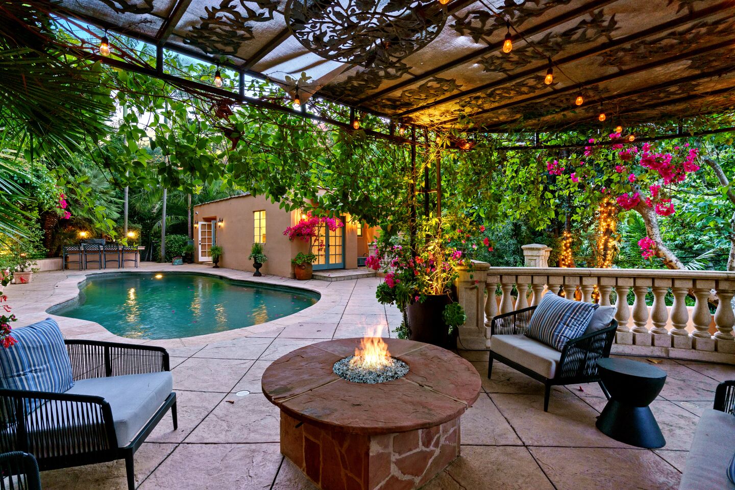 Courtyards, patios and a swimming pool with a separate pool house fill out the grounds.