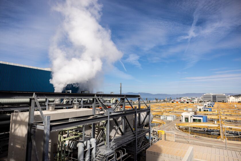 Los Angeles, CA - March 17: A view of the backside of Unit 5, which uses the waste heat from another turbine generator, to create steam and generate additional electricity, and the Hyperion Treatment Plant (yellow piping), at the Scattergood Generating Station, photographed in Los Angeles, CA, Thursday, March 17, 2022. The gas-fired power plant is operated by the Los Angeles Department of Water and Power and is one of the city's largest power sources. The DWP hopes to transition from burning natural gas to burning green hydrogen at Scattergood. (Jay L. Clendenin / Los Angeles Times)