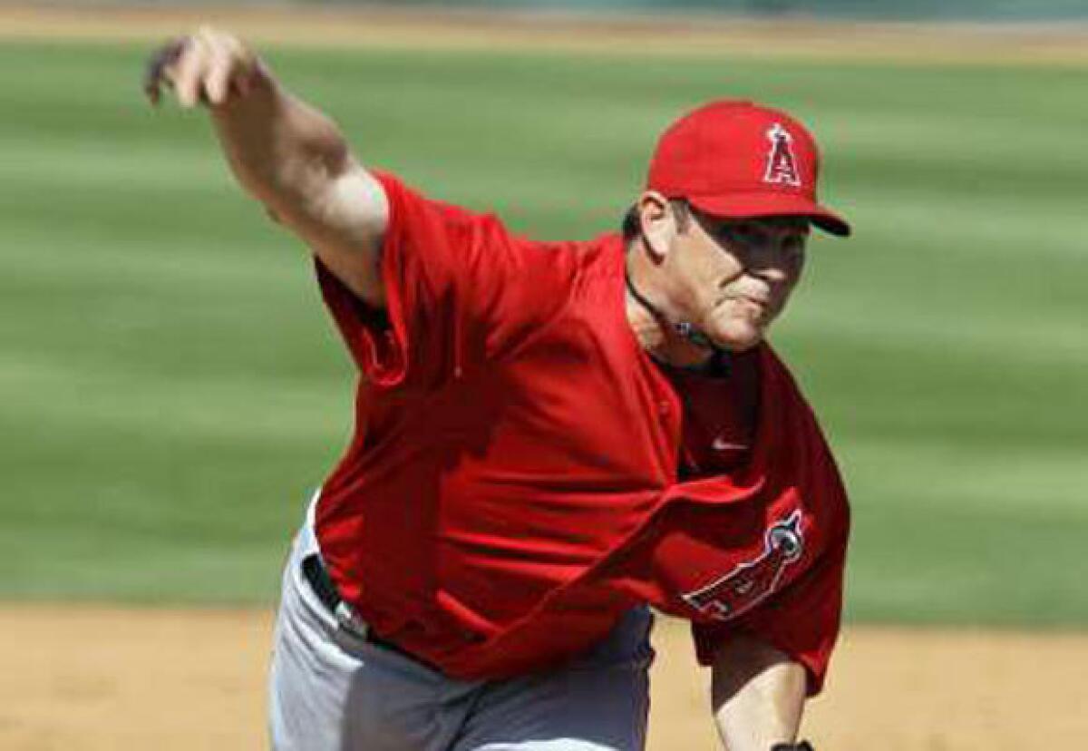 Jason Isringhausen delivers against the Cincinnati Reds in a spring training game.