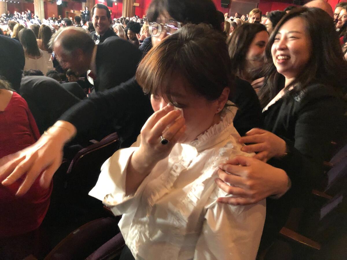 Jung Sun-Young, wife of "Parasite" director Bong Joon Ho, wipes away her tears after the film is named best picture at the 92nd Academy Awards.