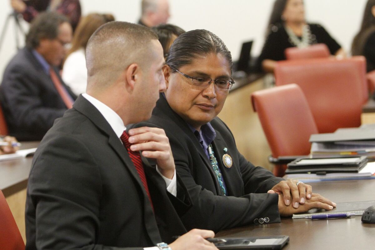 Navajo Nation presidential candidate Christopher Deschene, right, was removed from the ballot by the tribe's high court.