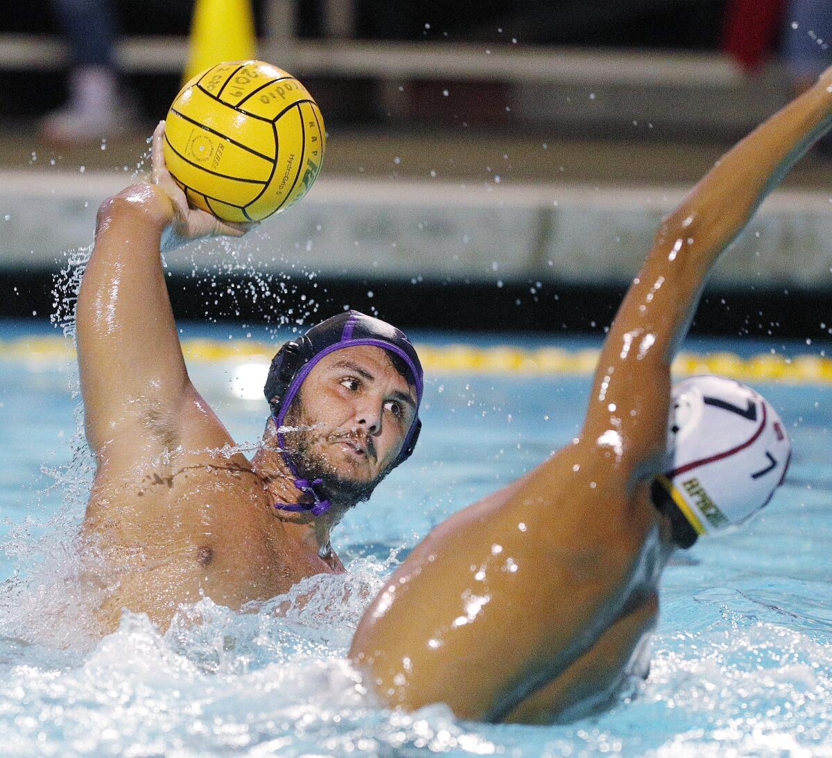 Hoover's Hayk Nazaryan shoots a motivated shot with Arcadia's Tyler Ybarra reaching out to defend in a Pacific League boys' water polo final at Arcadia High School on Thursday, October 31, 2019. Hoover won the Pacific League title beating Arcadia 10-6.