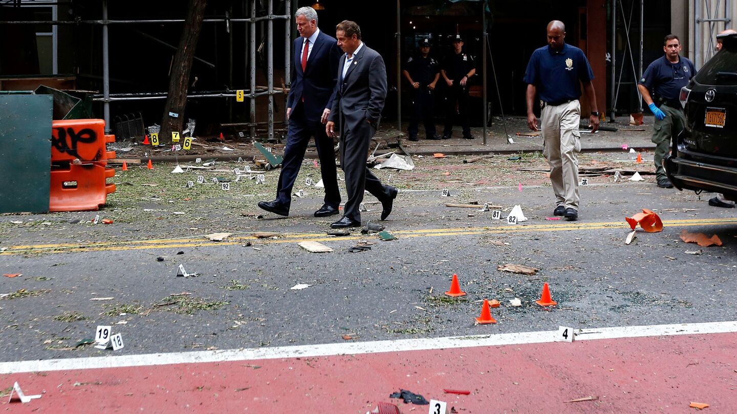 New York Mayor Bill de Blasio, left, and New York Gov. Andrew Cuomo tour the site of the explosion.