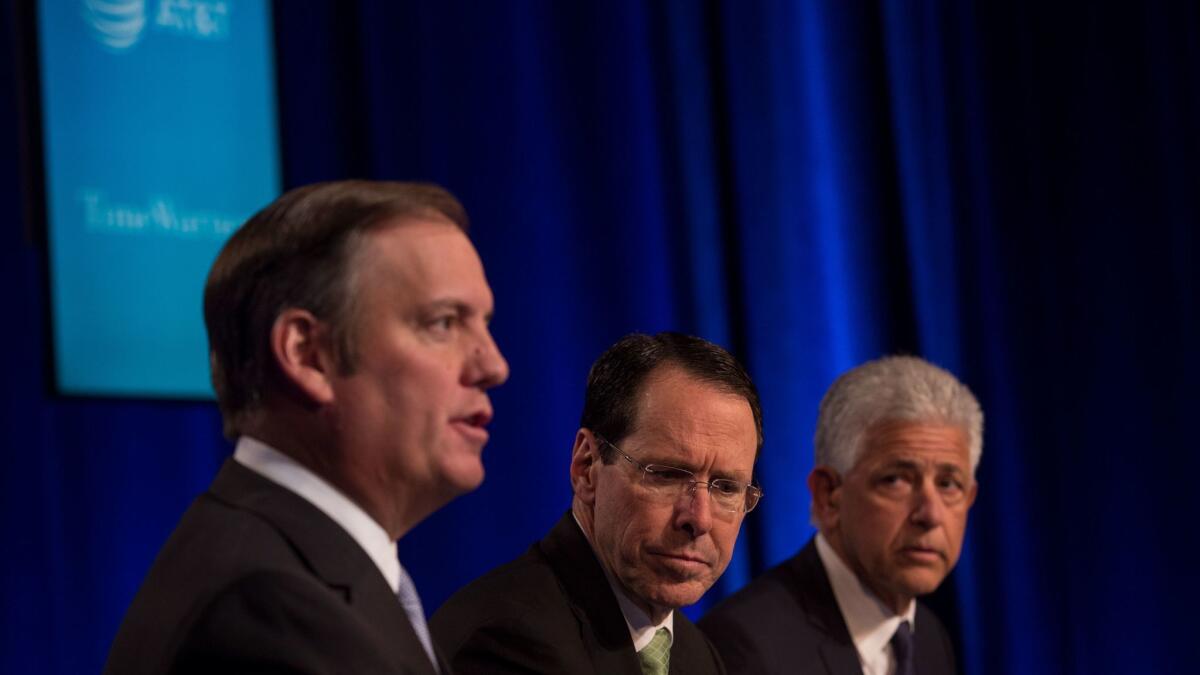AT&T General Counsel David R. McAtee II, left, AT&T Chief Executive Randall Stephenson and attorney Daniel Petrocelli discuss the Justice Department lawsuit at a news conference this month.