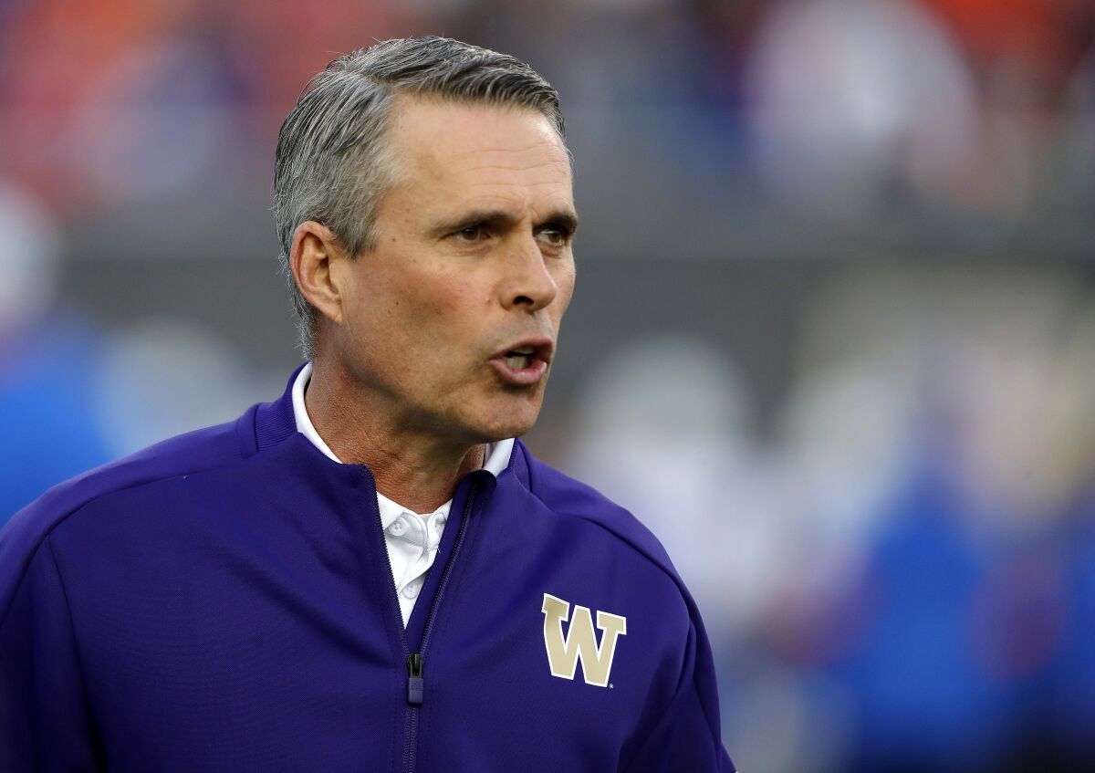 Washington head coach Chris Petersen instructs his players in December 2019.