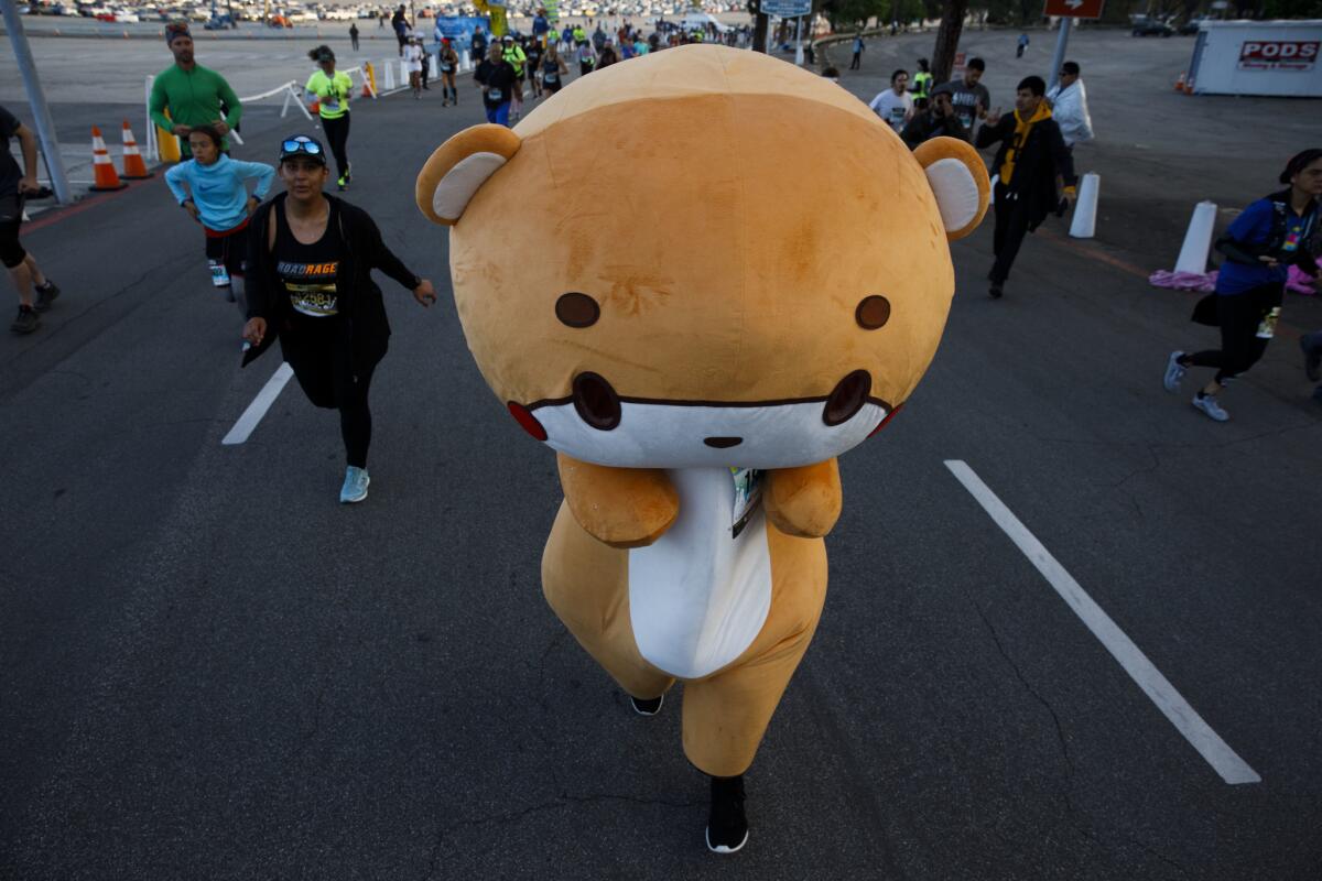 A costumed runner makes their way uphill at the start of the 34th annual L.A. Marathon at Dodger Stadium on Sunday in Los Angeles.