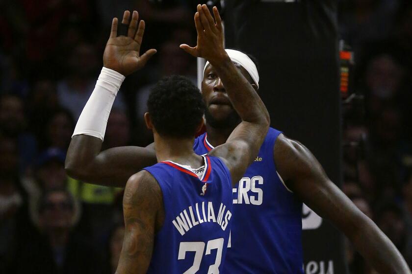 LOS ANGELES, CALIF. - NOV. 24, 2019. Clippers forward Montrezl Harrell is congratulated by teammate Lou Williams after scoring a basket againt the Pelicans in the fourth quarter at Staples Center in Los Angeles on Sunday night, Nov. 24, 2019. (Luis Sinco/Los Angeles Times)