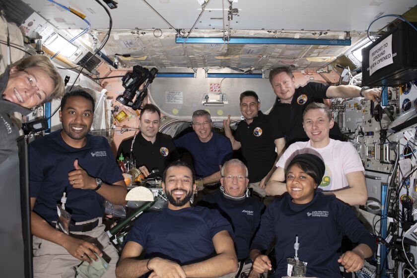 In this photo provided by NASA, Axiom Mission-2 and Expedition 69 crew members gather for a portrait together during dinner time aboard the International Space Station on Tuesday, May 23, 2023. At center front row is Expedition 69 crew member and United Arab Emirates astronaut Sultan Alneyadi flanked by, from left, Axiom Mission-2 crew members Commander Peggy Whitson, Mission Specialist Ali Alqarni, Pilot John Shoffner, and Mission Specialist Rayyanah Barnawi. In back from left are Expedition 69 crew members Roscosmos cosmonaut Dmitri Petelin, NASA astronaut Stephen Bowen, Roscosmos cosmonauts Andrey Fedyaev and Sergey Prokopyev, and NASA astronaut Woody Hoburg. Not pictured is NASA astronaut Frank Rubio. (NASA via AP)