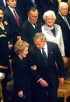 President Bush helps Nancy Reagan