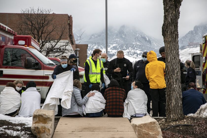 BOULDER, CO - MARCH 22: Healthcare workers and shoppers are tended to after being evacuated from a King Soopers grocery store after a gunman opened fire on March 22, 2021 in Boulder, Colorado. Dozens of police responded to the afternoon shooting in which at least one witness described three people who appeared to be wounded, according to published reports. (Photo by Chet Strange/Getty Images))