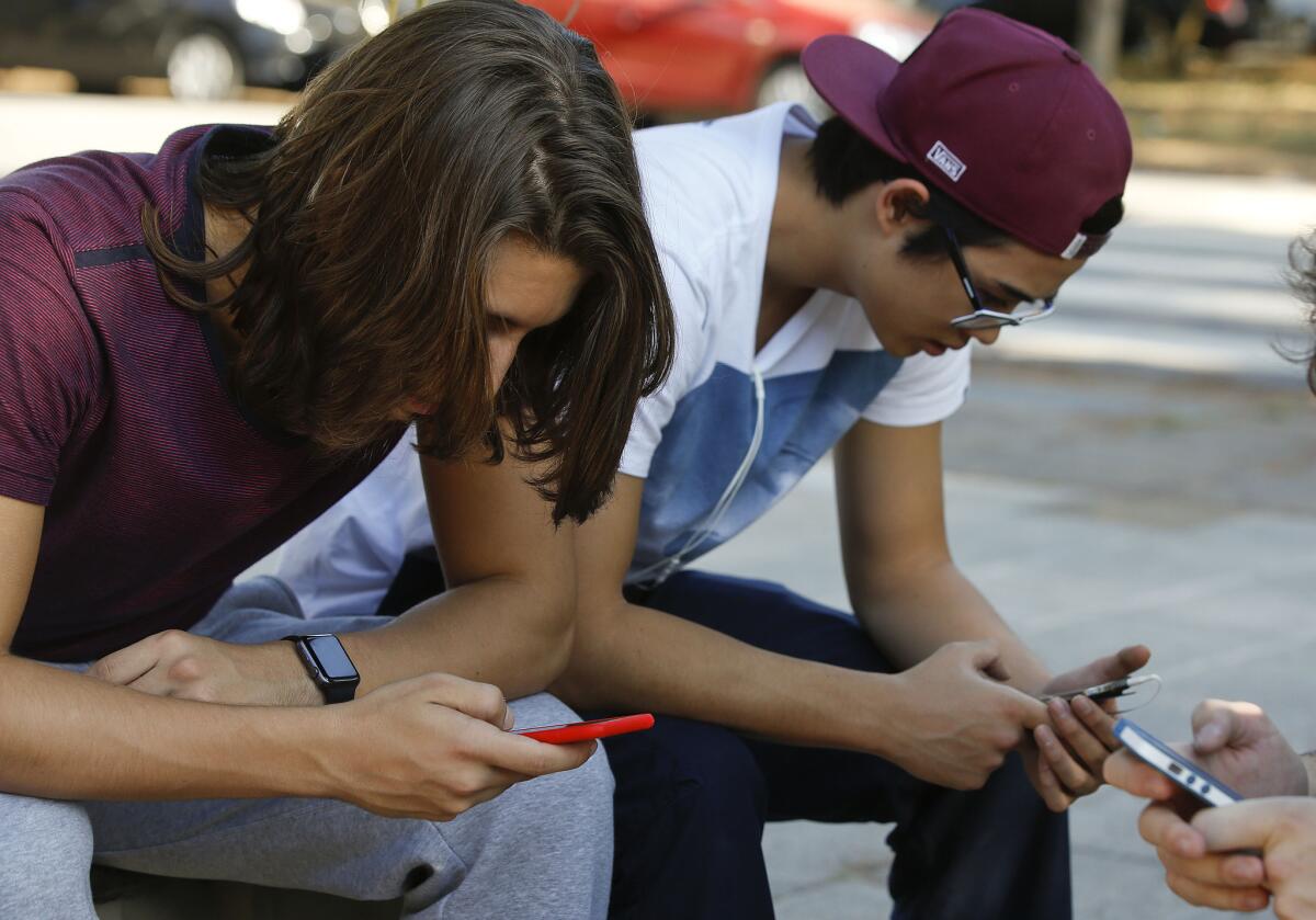 Brazilians check their cellphones in Sao Paulo on Monday.