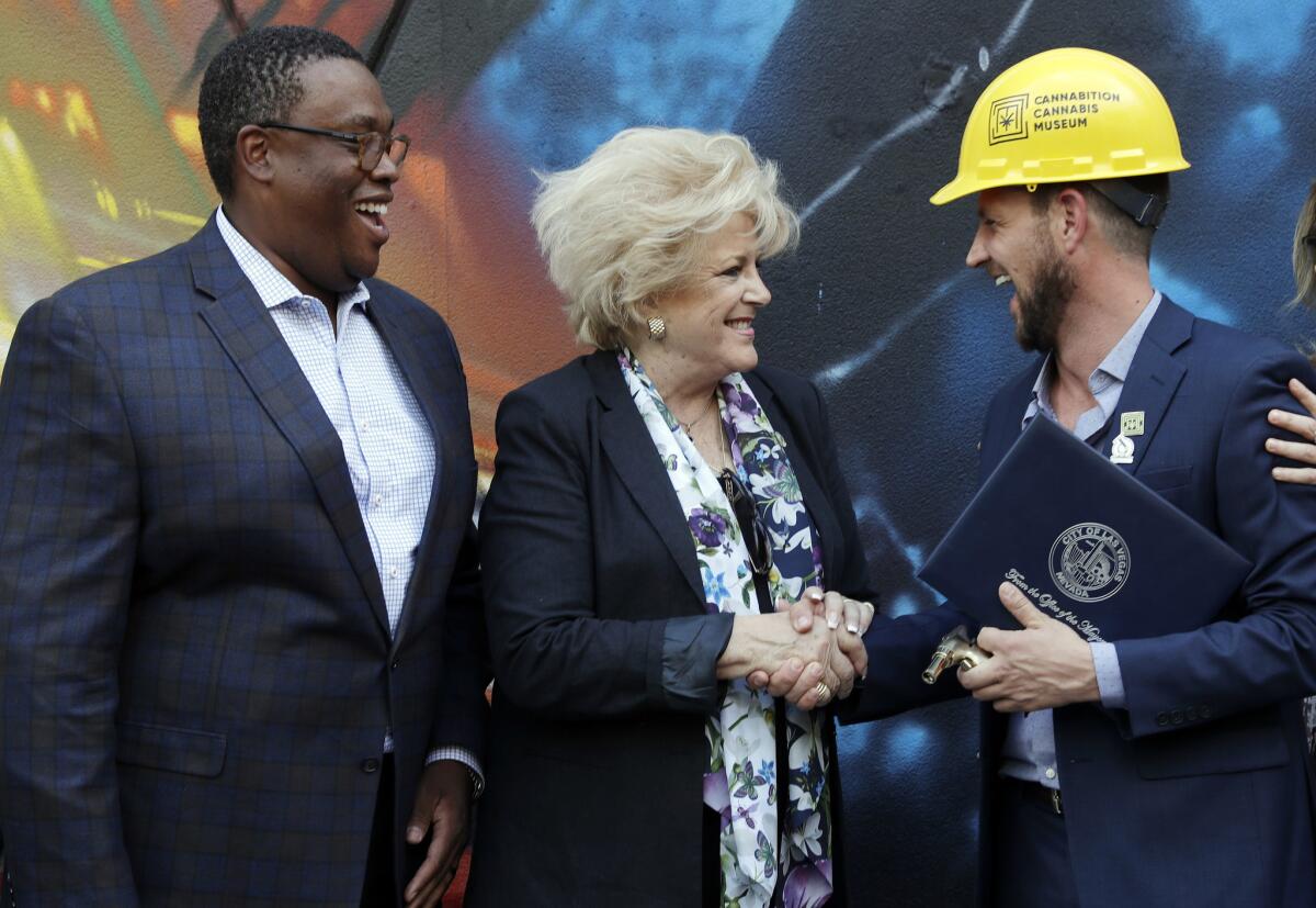 Las Vegas City Councilman Cedric Crear, left, Mayor Carolyn Goodman, center and Cannabition founder J.J. Walker, right, congratulate each other during a media preview of Cannabition Cannabis Museum Thursday, Aug. 30, 2018, in Las Vegas.