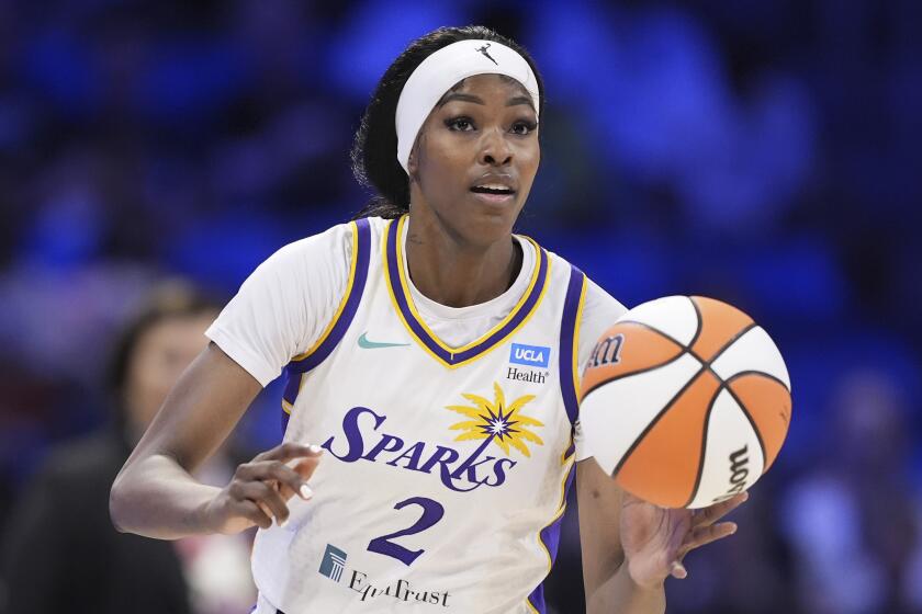 Los Angeles Sparks' Rickea Jackson handles the ball during a WNBA basketball game.