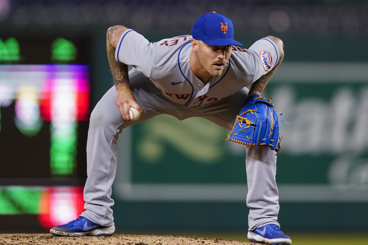 New York Mets relief pitcher Sean Reid-Foley looks to the catcher during the ninth inning of the team's baseball game against the Washington Nationals at Nationals Park, Friday, April 8, 2022, in Washington. The Mets won 7-3. (AP Photo/Alex Brandon)